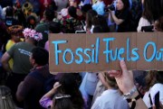 A protester holds a sign reading “Fossil Fuels Out” during a demonstration at the COP27 U.N. Climate Summit, in Sharm el-Sheikh, Egypt.