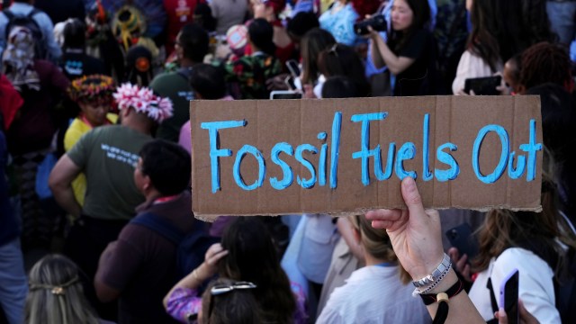 A protester holds a sign reading “Fossil Fuels Out” during a demonstration at the COP27 U.N. Climate Summit, in Sharm el-Sheikh, Egypt.