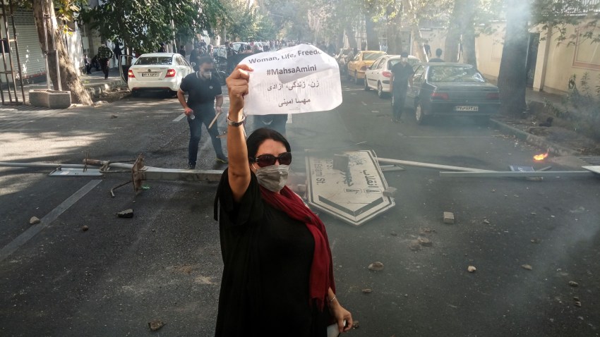A woman protests in Iran after the death of Mahsa Amini