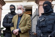 Far-right coup-plotter is led away by police in Germany for threatening the country's democracy and political stability