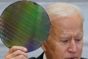 U.S. President Joe Biden holds up a silicon wafer.