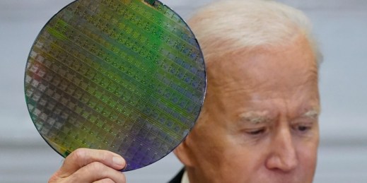 U.S. President Joe Biden holds up a silicon wafer.