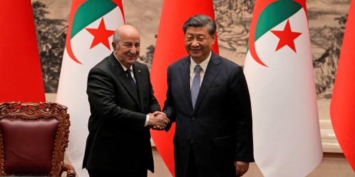 Algerian President Abdelmadjid Tebboune shakes hands with Chinese President Xi Jinping.