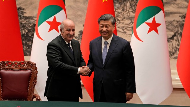 Algerian President Abdelmadjid Tebboune shakes hands with Chinese President Xi Jinping.