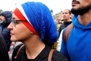 A woman wearing a headscarf in the colors of the French flag