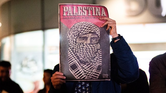 A demonstrator holds up a sign reading, “Palestine,” at a rally outside the Israeli Embassy in Bogota