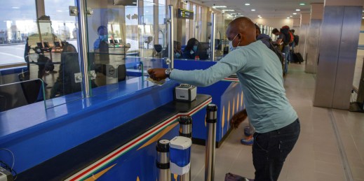 A passenger from Kigali, Rwanda, waits to be cleared by immigration officials at Jomo Kenyatta International Airport in Nairobi, Kenya, Aug. 1, 2020.