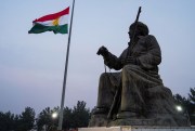 The Kurdistan flag is seen waving over a statue of Kurdish leader Mulla Mustafa Barzani, founder of the Kurdistan Democratic Party, Dec. 17, 2021.
