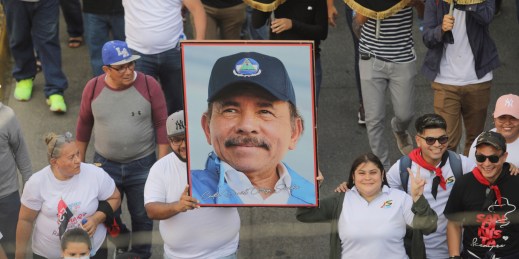 A man carries a portrait of President Daniel Ortega during a pro-government march in Managua, Nicaragua, Feb. 11, 2023.