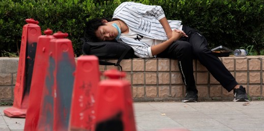 A man takes a nap on the street, in Beijing. China, Sept. 14, 2020.