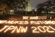 Lighted candles spell out, “No Nukes Future! TPNW 2021."