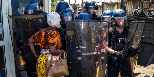 A protester confronts riot police in Mayotte.
