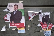 Torn electoral posters in Tehran.