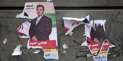 Torn electoral posters in Tehran.