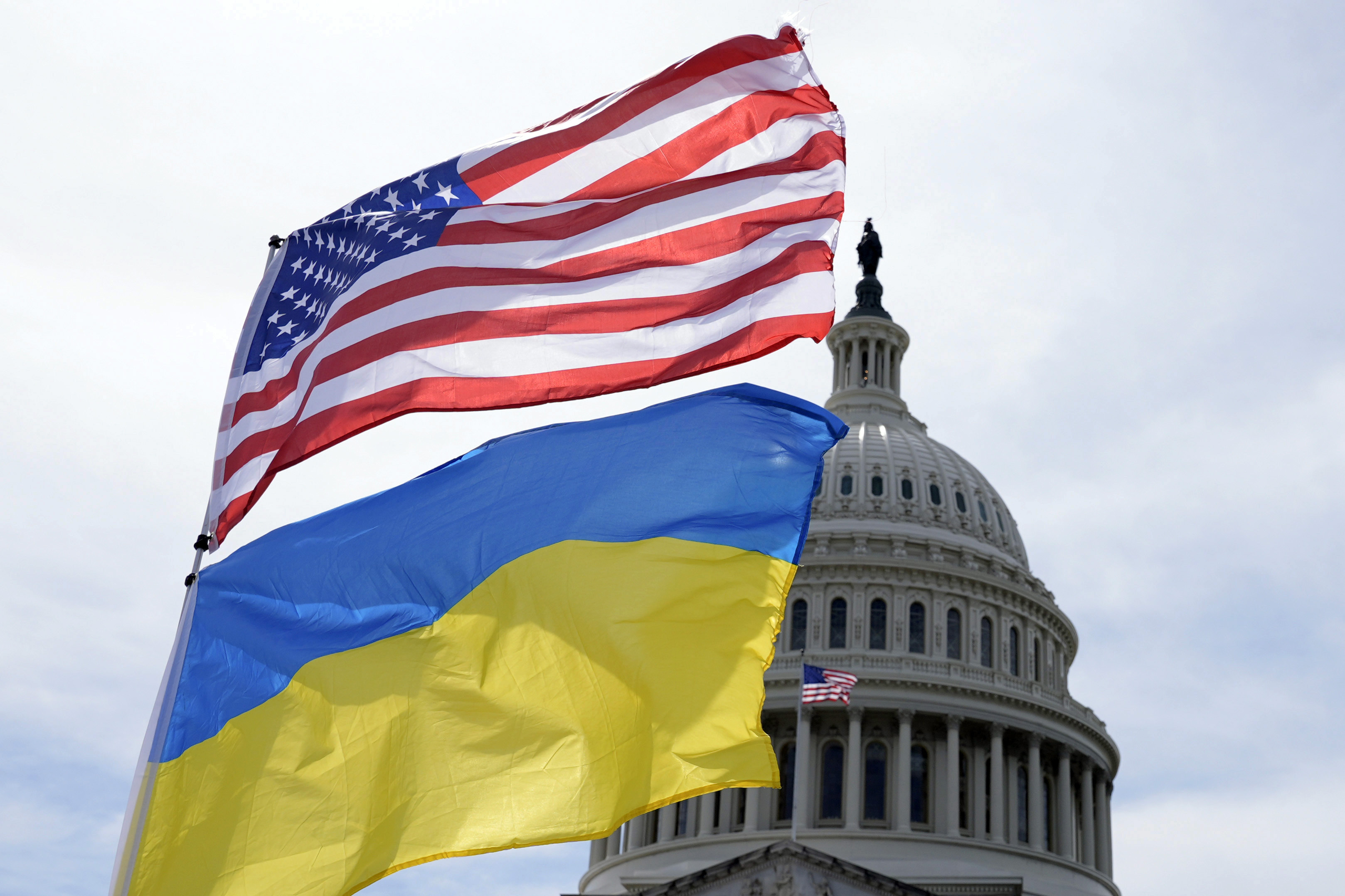 The American and Ukrainian flags wave.