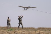 Israeli soldiers launch a drone.