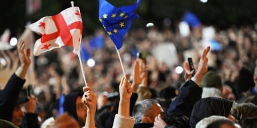 Opposition supporters hold up Georgian and EU flags in Tbilisi.