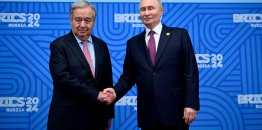 U.N. Secretary-General Antonio Guterres shakes hands with Russian President Vladimir Putin.