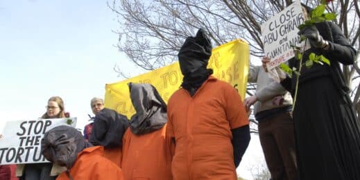 Demonstrators dressed as prisoners at Abu Ghraib protest the war in Iraq.