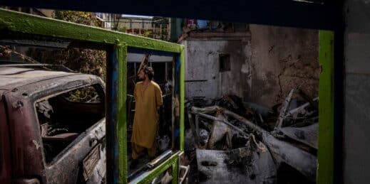 An Afghan inspects the damage from the US drone strike.