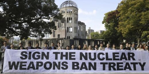 A banner reading “Sign the Nuclear Weapons Ban Treaty”.
