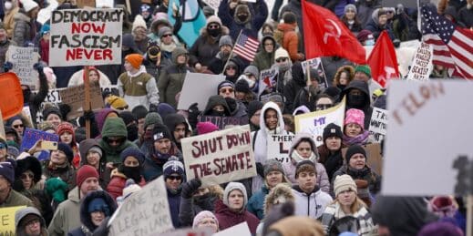 Protesters display signs during the Trump and Project 2025 Protest.