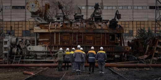 Ukrainian power plant workers inspect a voltage transformer that was destroyed after a Russian attack.
