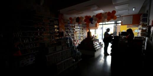 A customer stands inside a store affected by a power outage in Buenos Aires.