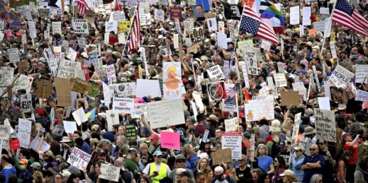 Demonstrators protest against the policies of U.S. President Donald Trump.