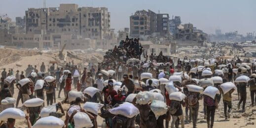 Palestinians carry humanitarian aid in Gaza.