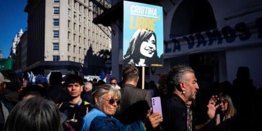 Protesters hold a sign with a portrait of former President Cristina Fernandez de Kirchner.