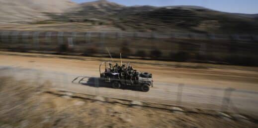 Israeli soldiers on an armored vehicle.
