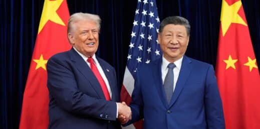 Donald Trump and Xi Jinping shake hands.