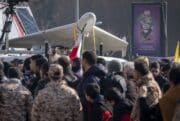 A crowd gathers in front of a Shahed drone in Tehran.