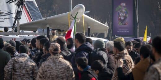 A crowd gathers in front of a Shahed drone in Tehran.